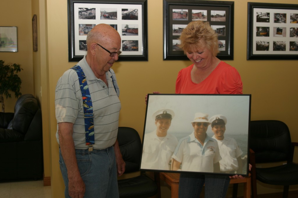 Jennifer Redfearn and her father, Jack Graves, look at a picture of the boys from their Navy Tiger Cruise.