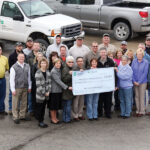 Pictured on the front row from left are Roxy Theatre manager Camice Barker, ­committee members Gwyn Helton, Carol Cole, and Brad Jiter, Shelby Electric employee Vicki Blackwell, CoBank representative John Donner, Shelby Electric employee Bev Carlen. Surrounding them are employees of Shelby Electric Cooperative.