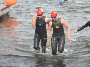 Ashley (left) and guide Lindsey Cook leave the water after the swimming leg of the race.