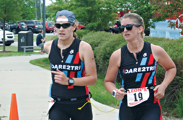 Ashley, left, and guide Lindsey Cook complete the final leg of the Leon’s World’s Triathlon in Hammond, Ind.