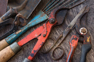 Old rusty tools - dirty tools - vintage garden tools on wooden background