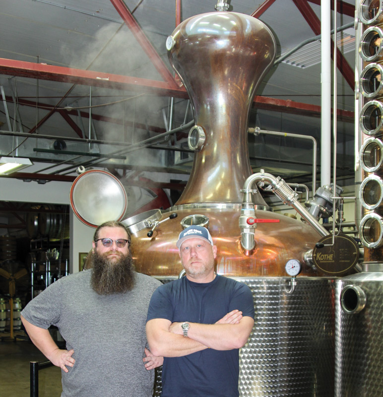 Mike and Matt Blaum, co-owners of Blaum Bros. Distilling Co. stand by their still.