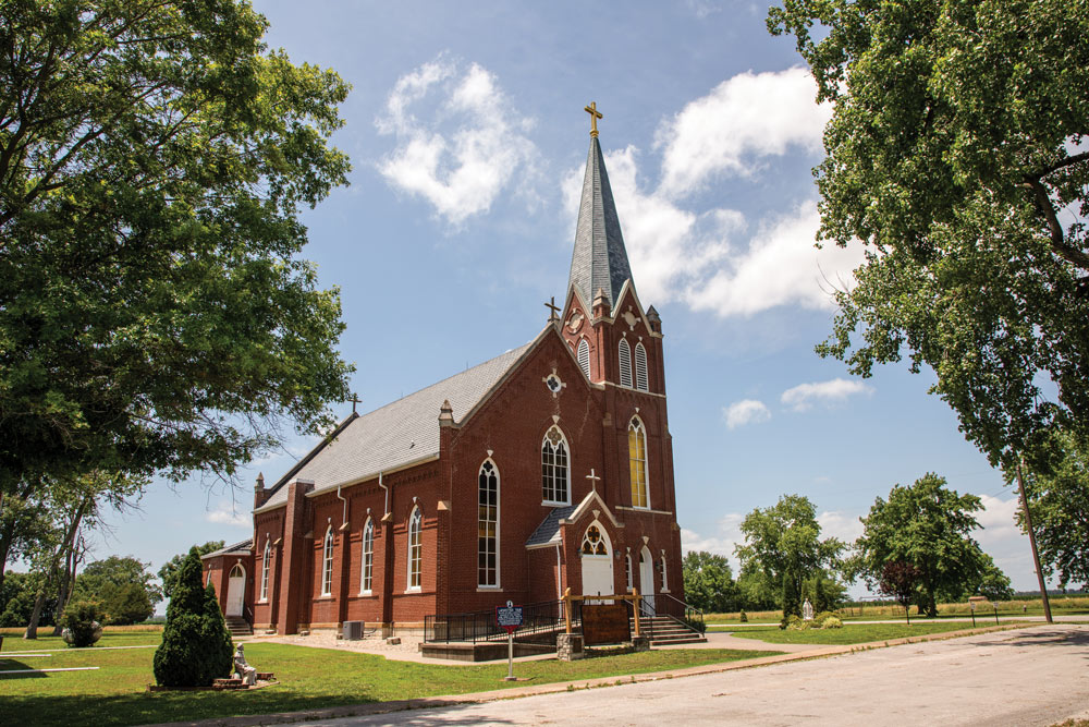 A brick church between two trees