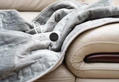 electric blanket with controller on a sofa