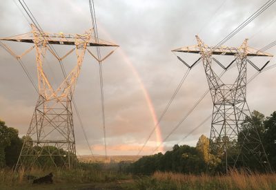 Rainbow between two power lines.