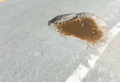 Photo of pothole in the road.