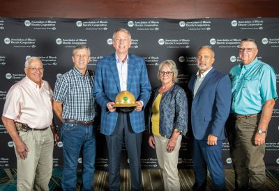 SouthEastern Illinois Electric Cooperative (SEIEC) representatives present State Representative Patrick Windhorst with the 2024 Illinois Electric Cooperatives’ Public Service Award. Pictured from left: SEIEC Board Directors Joe Marlo and Dale Schierbaum, Representative Windhorst, Board Director Pamela Bramlet, President/CEO Dustin Tripp and Board Director Jamie Scherrer.