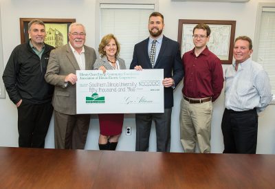 A GeoAlliance grant check to help fund a geothermal system in the Transportation Education Center was recently presented to officials of Southern Illinois University (SIU). From left are: Phil Gatton, SIU director of plant and service operations; Bryce Cramer, Egyptian Electric Cooperative Association district office and member services manager, Murphysboro; Nancy McDonald, AIEC marketing administrator; Andrew Croxell, SIU assistant professor, automotive technology; Justin Harrell, SIU engineer, physical plant services; and Bret Dougherty, SIU coordinator of administrative services, plant and service operations.