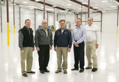 Soon this factory floor at IHI Turbo America in Shelbyville will have new equipment and 30 new employees making turbochargers for Audi. Inspecting the new addition are Josh Shallenberger, COO Shelby Electric Cooperative; John Schuessler, General Manager IHI Turbo America; James Coleman, President/CEO Shelby Electric; Mike Price, Controller IHI Turbo; and Aaron Ridenour, Marketing & Business Development Prairie Power, Inc.