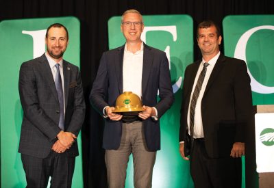 AIEC President/CEO Craig Sondgeroth (left) and AIEC Board Chairman Rick Rubenacker (right) present State Treasurer Michael Frerichs with the IEC Public Service Award.