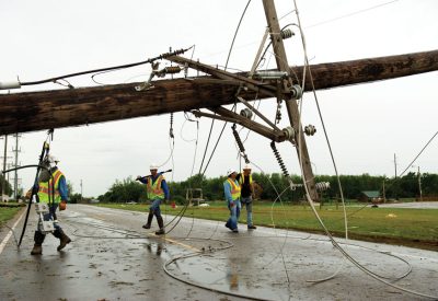 Western Farmers Electric Cooperative contractor crews work on damaged areas in the Moore, Okla.