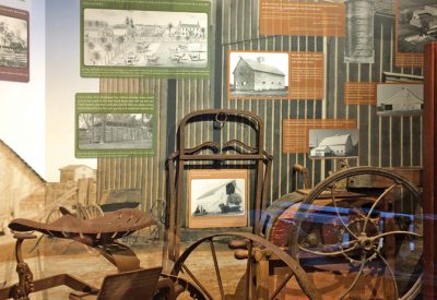 Farming exhibit with photos and antique farm implements